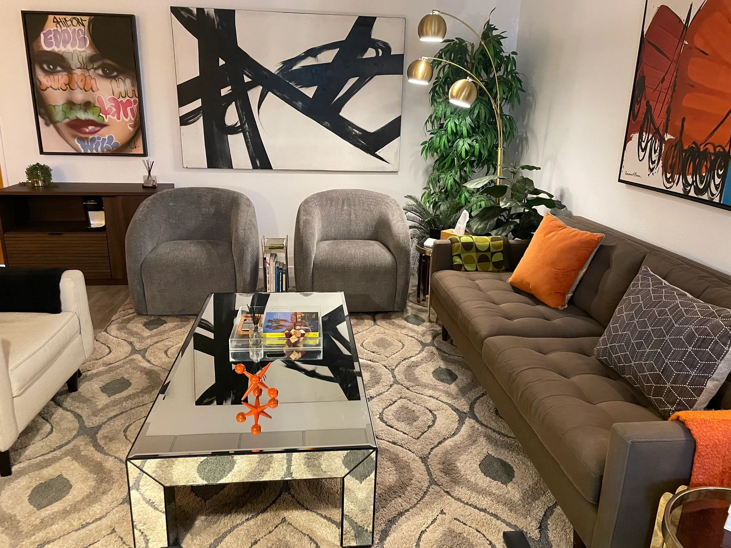 Cozy reading nook with a teal chair, warm lamp, and vibrant butterfly art.