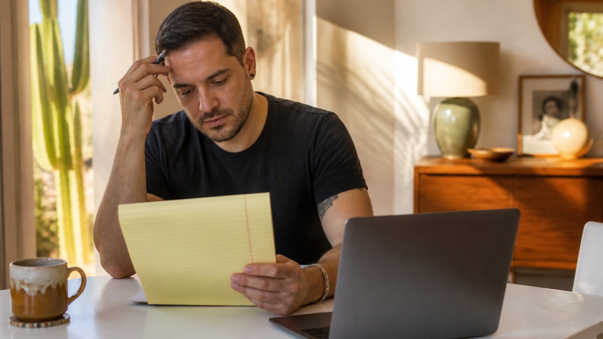 Person reviewing questions for a consultation with LGBTQ-friendly therapists in a sunlit home office